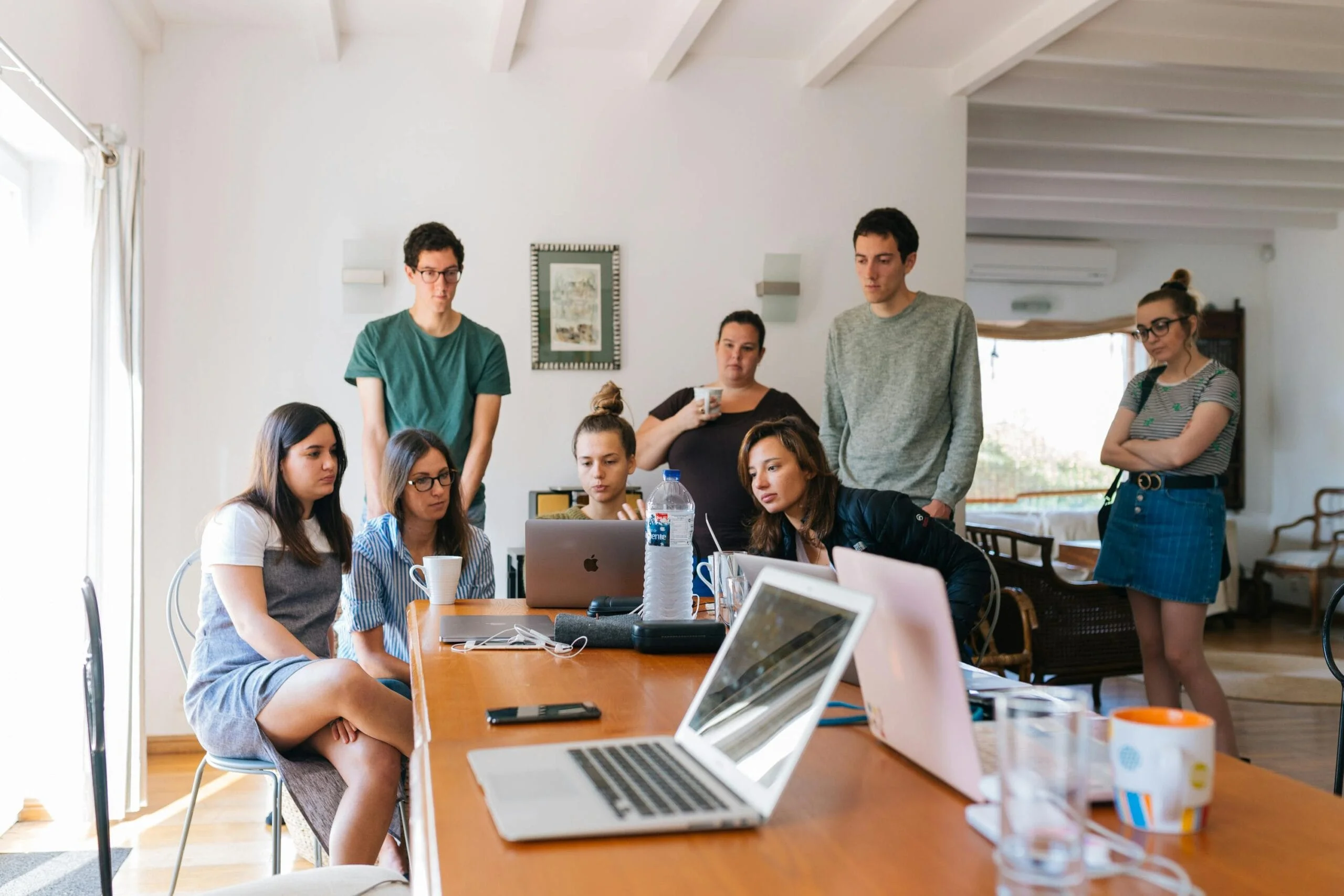 pexels-photo-1595385-1595385 Group of young professionals engaged in a collaborative meeting in a modern office setting.